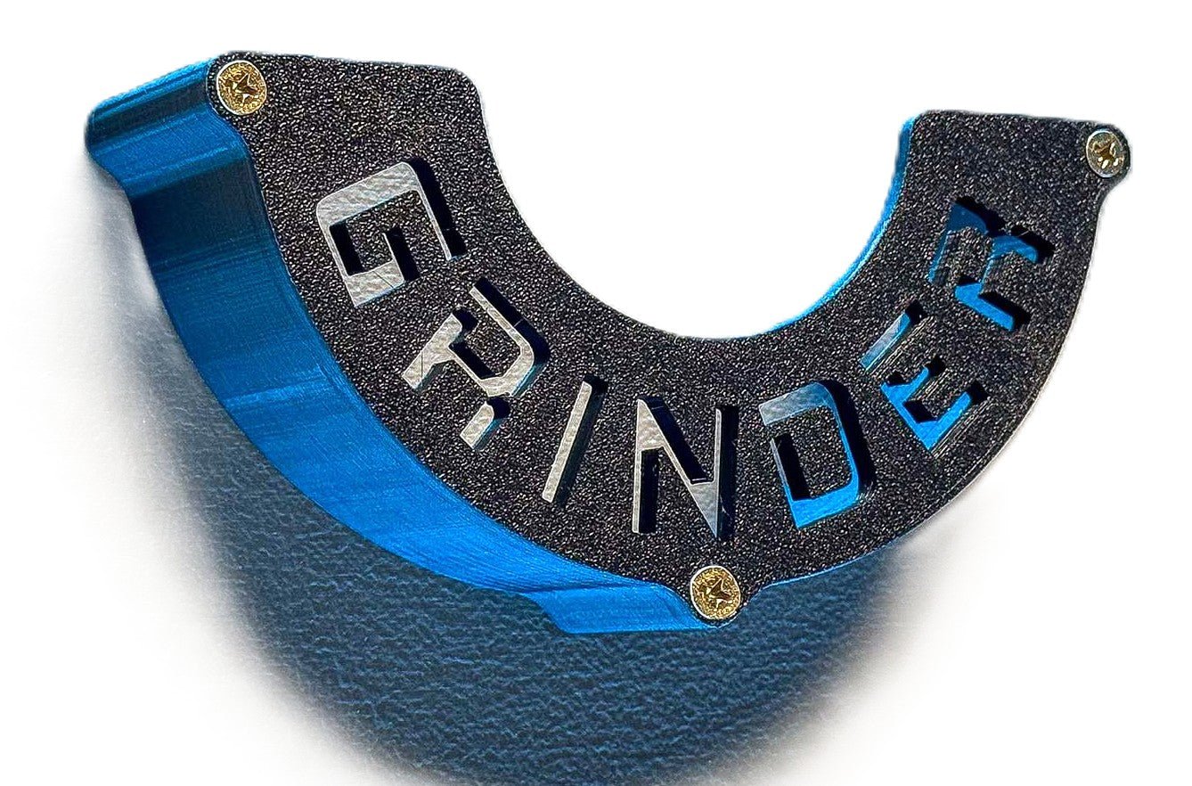 Close-up view of a black Angle Grinder Wall Mount featuring the word 'GRINDER', emphasizing its sturdy construction and tool organization.
