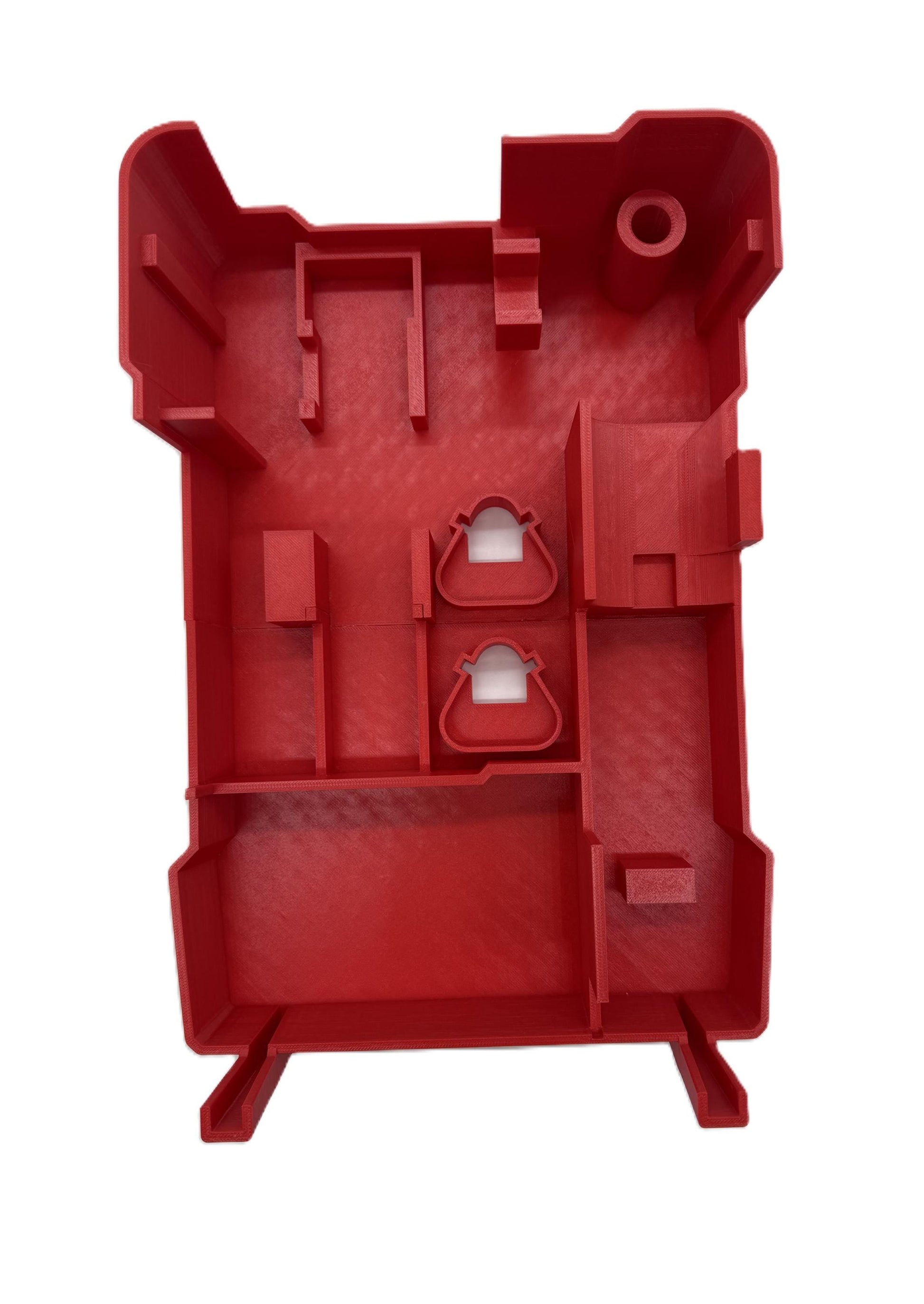a red plastic object with a hole in the middle