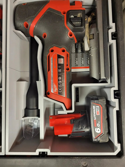 M12 Fuel Jigsaw and battery stored in a Milwaukee Packout insert compatible with Milwaukee tools. Perfect for organization and efficiency, this design minimizes tool movement during transport.