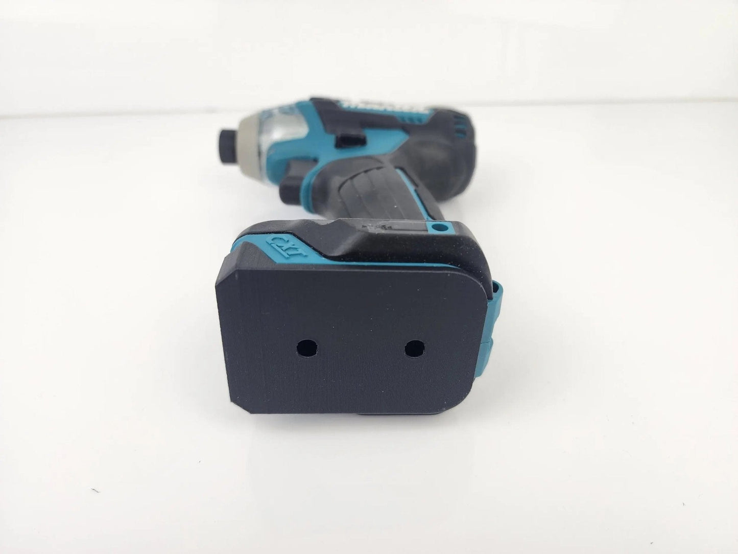 Close-up view of Makita M12 Deep Tool Holder showcasing a drill with a battery attachment, highlighting the secure fit for organized tool storage.