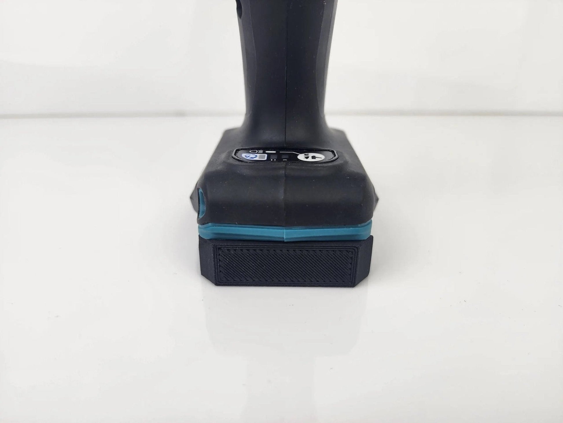 Front view of a battery compatible with the Makita M12 Deep Tool Holder - Wall-Mountable Battery Tool Organizer, showcasing the secure fit for efficient storage.