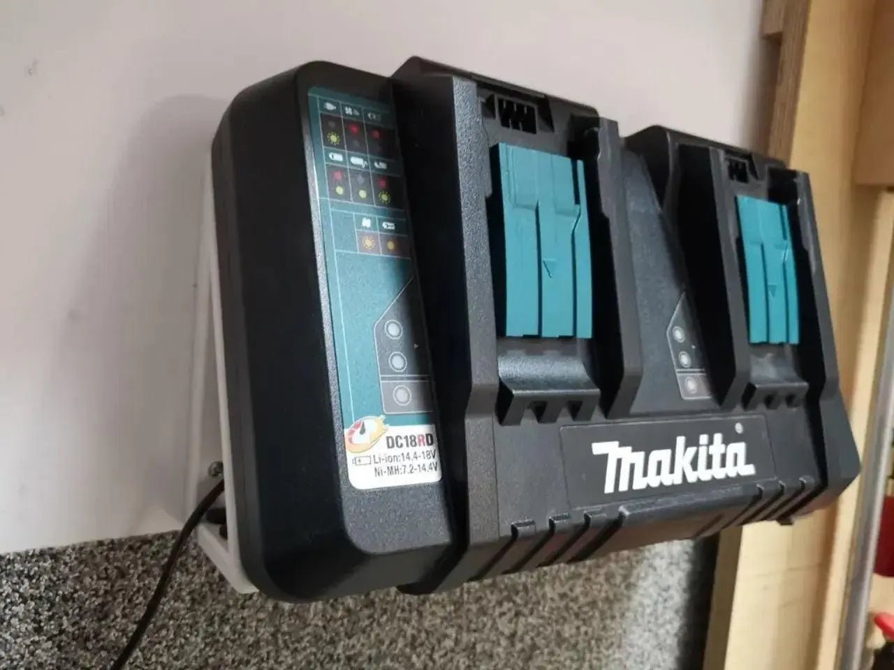 Makita 18V Dual Charger Wall Mount installed, showcasing dual charger slots for efficient tool organization and management.