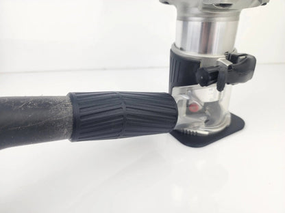 Close-up of the Makita 18V Router Vacuum Adaptor attached to a router, showcasing the dust collection accessory designed for 18V routers to maintain clean workspaces.