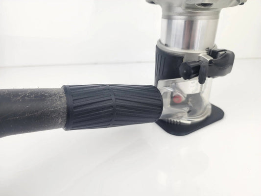 Close-up of the Makita 18V Router Vacuum Adaptor attached to a router, showcasing the dust collection accessory designed for 18V routers to maintain clean workspaces.