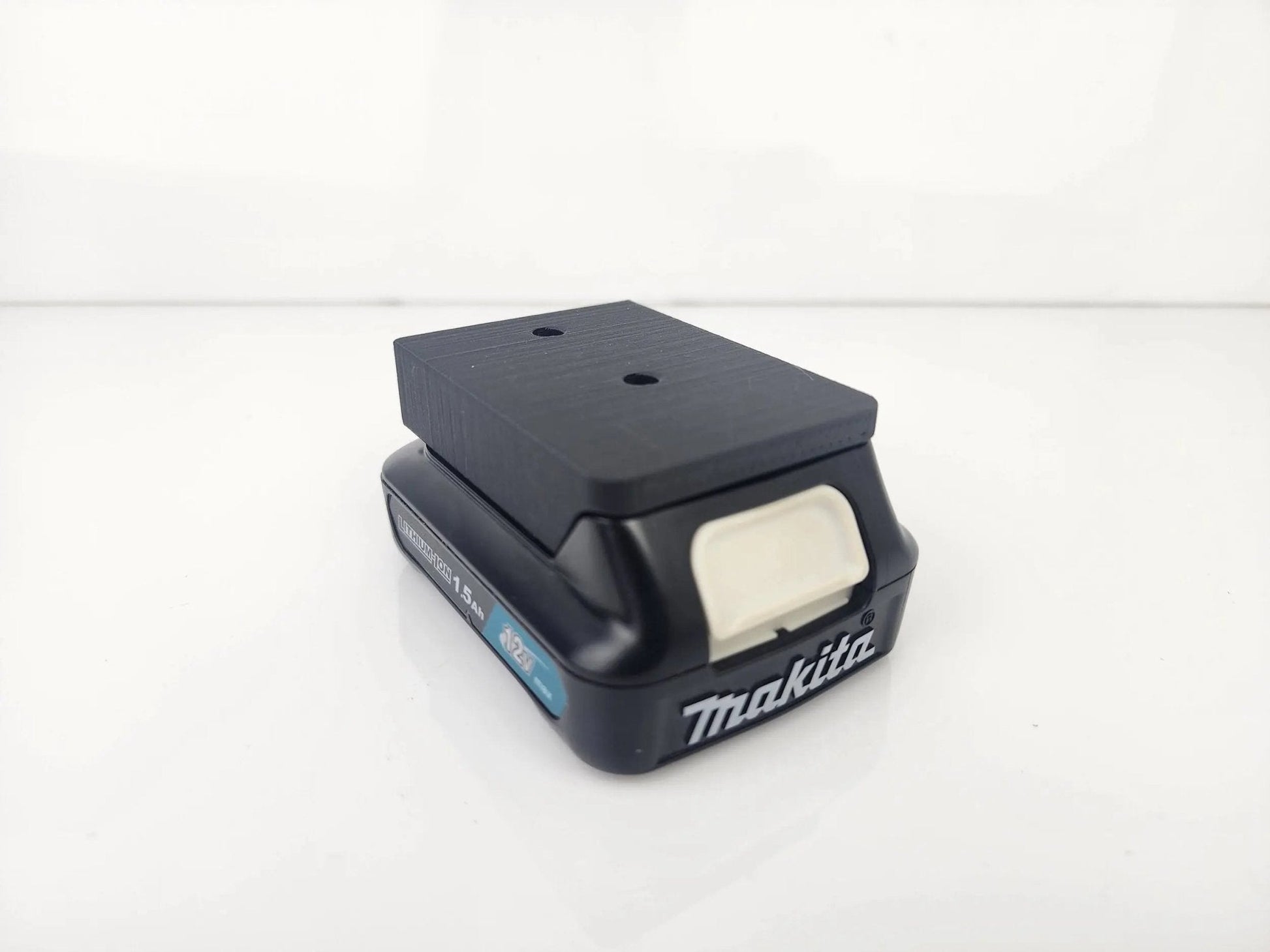 Makita M12 Wall-Mountable Battery Holder showcasing its robust construction and precision-fit design, ideal for organizing Makita batteries.