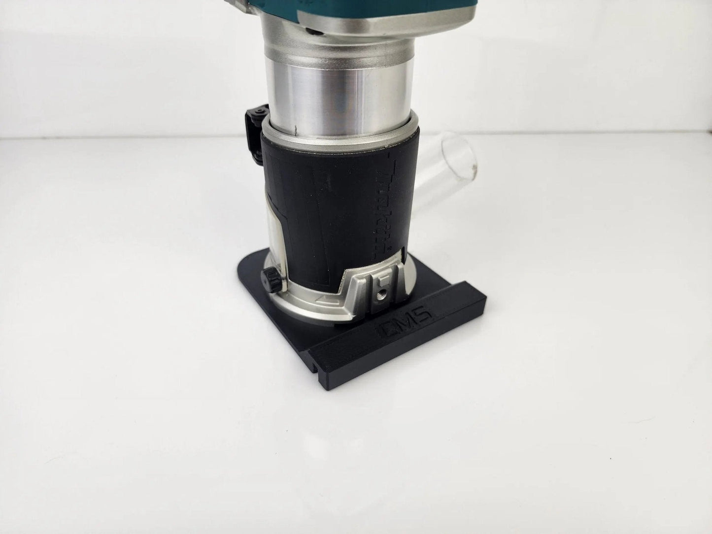 Rear view of Makita Router with attached Router Rail Guide, featuring dust extraction for cleaner operation during carpentry work.