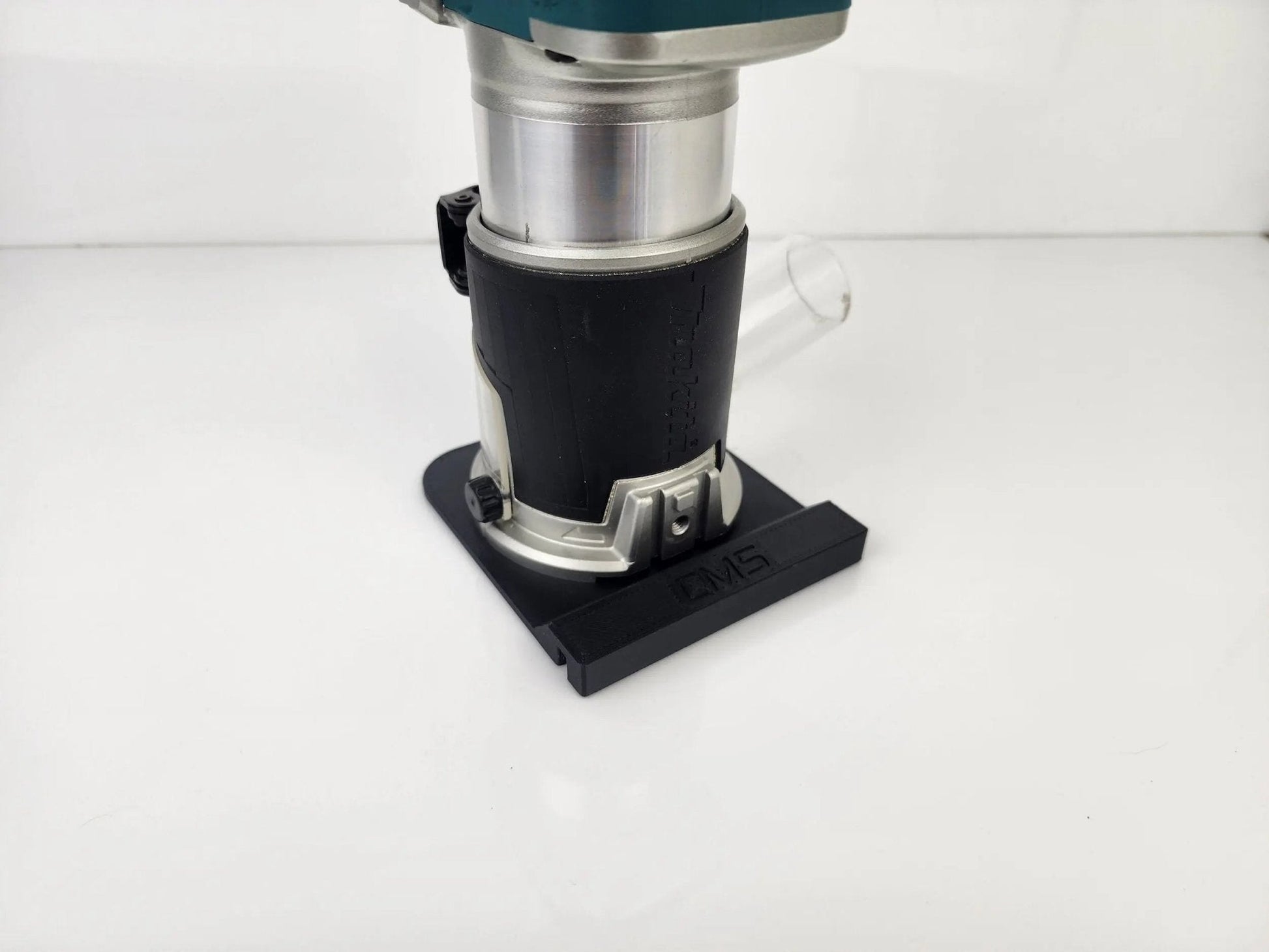 Rear view of Makita Router with attached Router Rail Guide, featuring dust extraction for cleaner operation during carpentry work.