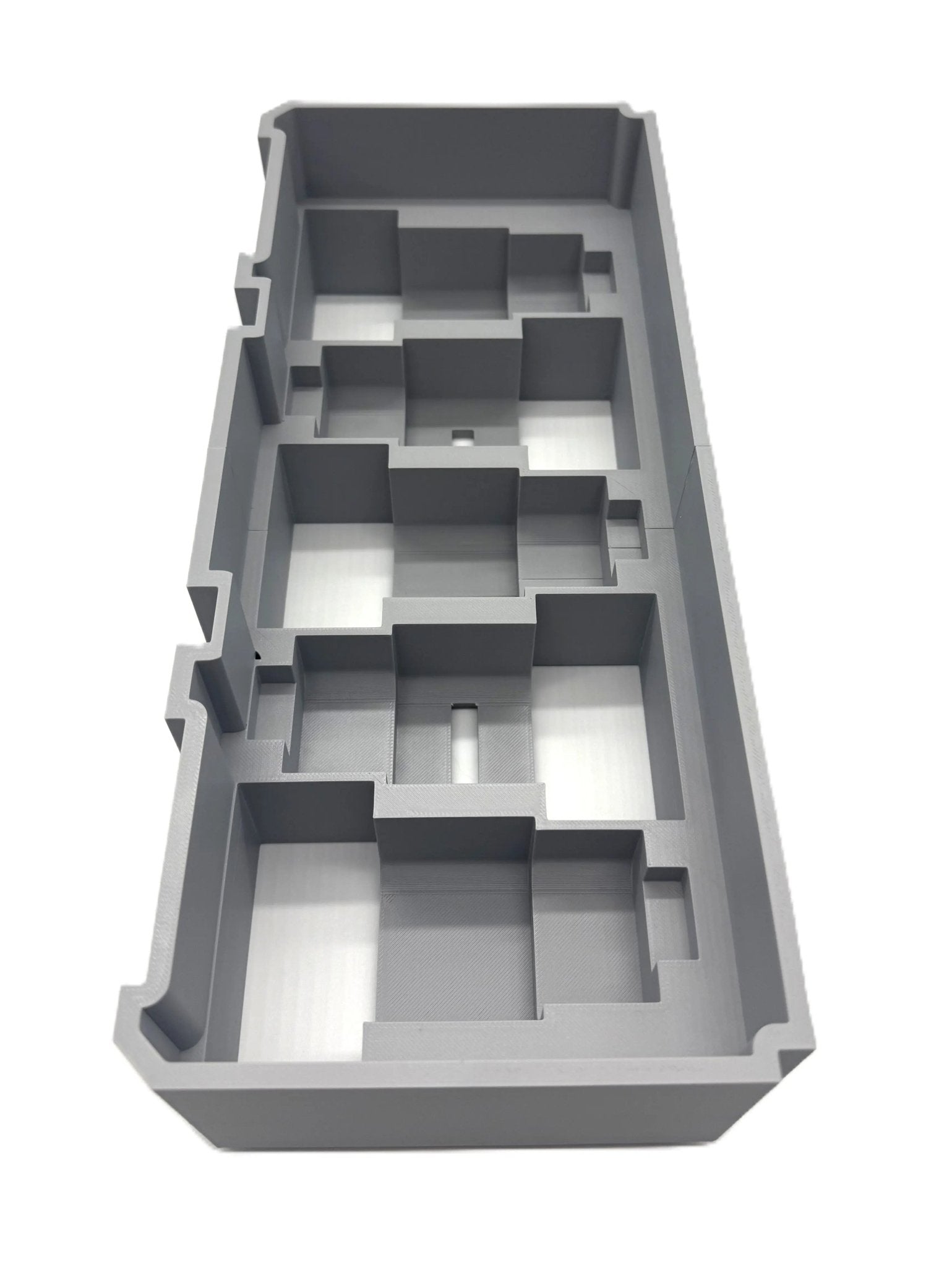 Milwaukee Packout Insert for M12 4.0Ah & 6.0Ah Batteries - Gray plastic storage insert designed to fit Milwaukee Packout boxes, showcasing individual slots for organized tool storage.