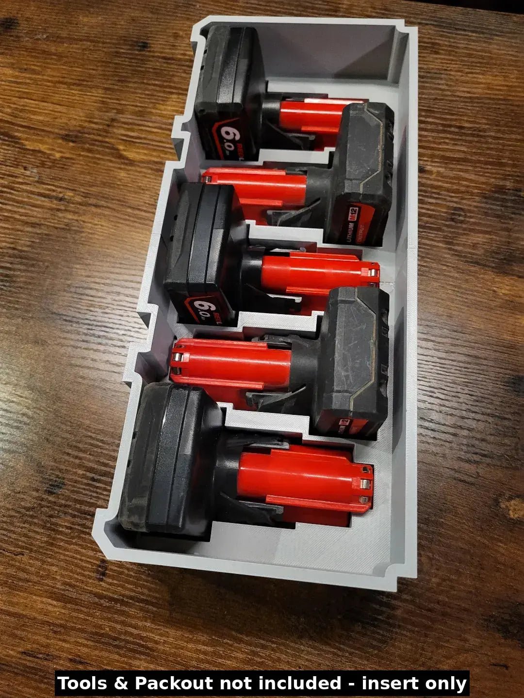 Milwaukee Packout Insert for M12 4.0Ah & 6.0Ah Batteries - Image displaying the insert holding four Milwaukee batteries securely, emphasizing organization and accessibility for tools.