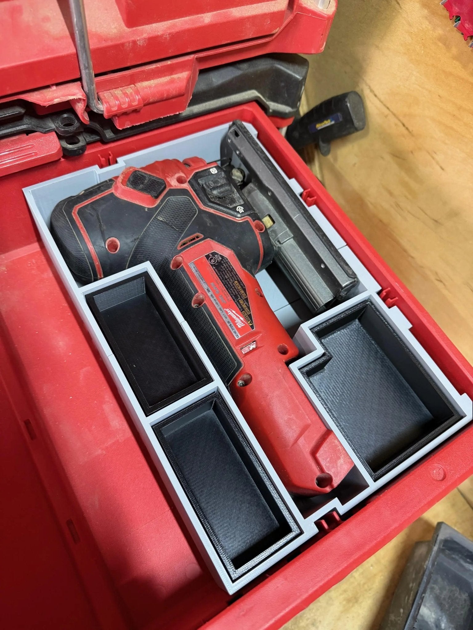 Insert to Suit Jigsaw Organizer – Compatible with Milwaukee Packout, demonstrated in use with a Milwaukee tool placed securely within the red organizer.