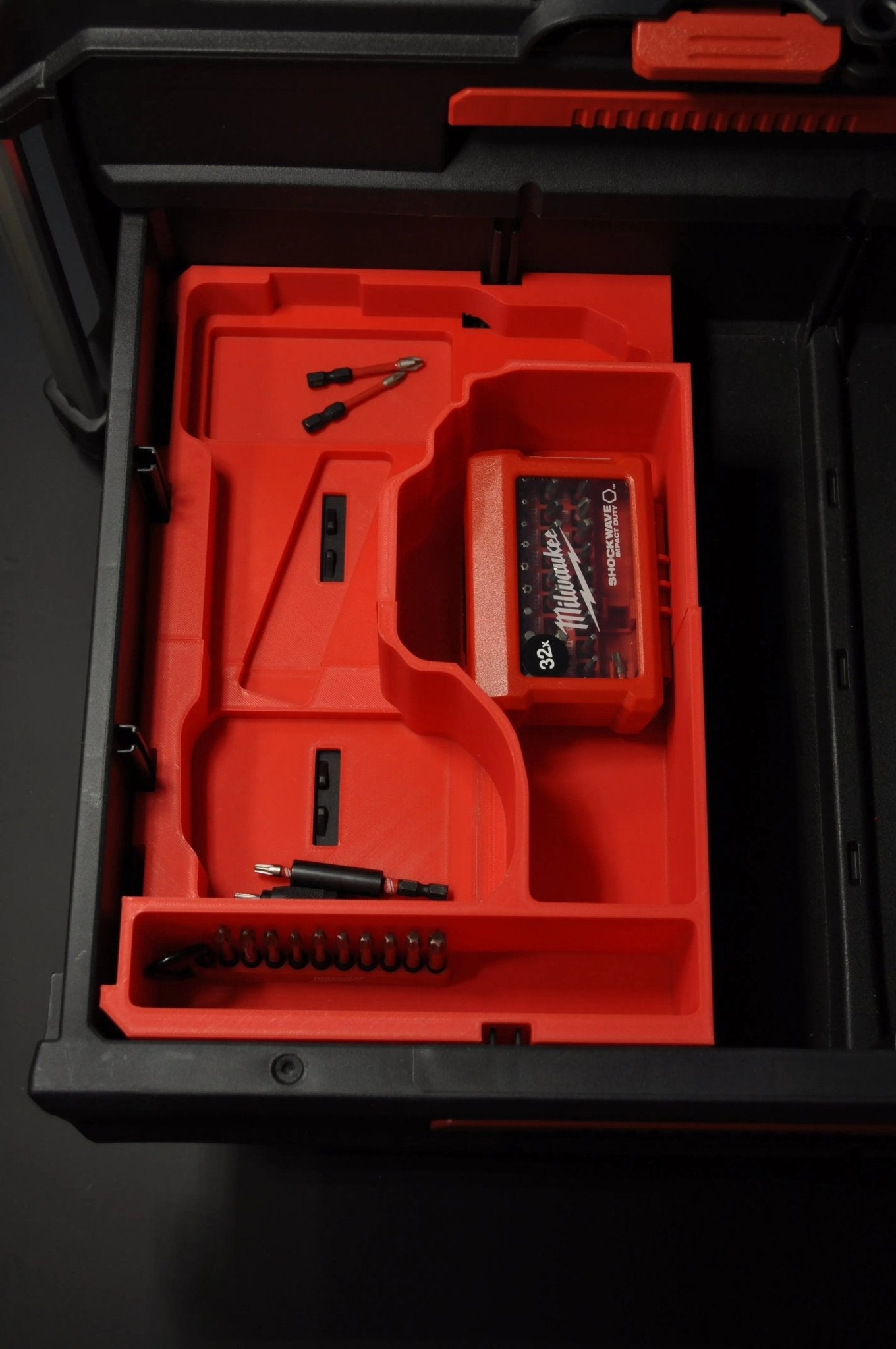 Interior view of Milwaukee Packout box tailored for M18 Fuel Hammer Drill Gen 4, showcasing the organized layout for tools and accessories, promoting efficient storage.