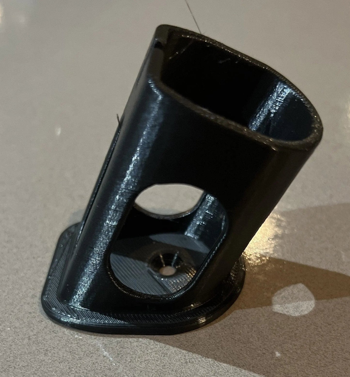 Side perspective of a Ryobi battery holder, demonstrating its design and functionality, a key feature of the Ryobi 18V One+ Battery Holder – Wall-Mountable Organizer for Clean Garage.