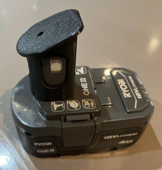 Close-up of a Ryobi 18V One+ battery showing the unique design and branding, illustrating the product benefits of the Ryobi 18V One+ Battery Holder – Wall-Mountable Organizer for Clean Garage.