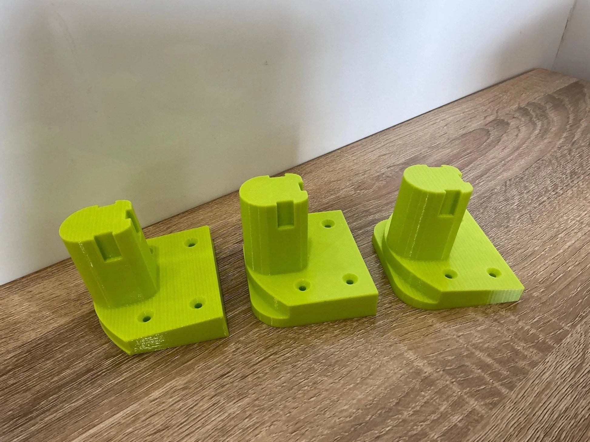 Ryobi Tool Mounts for Efficient Wall or Bench Storage – Organize Garage & Workshop. Close-up view of three sturdy tool mounts, perfect for keeping garage tools organized and accessible.