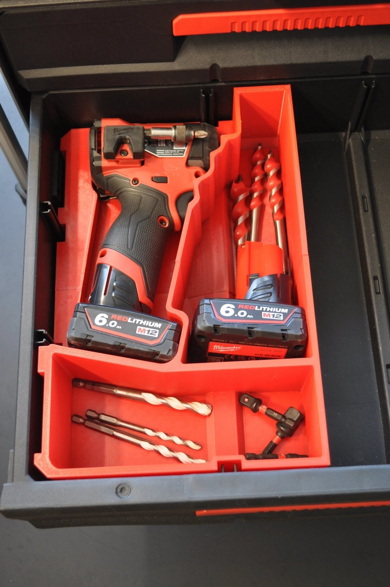 Close-up of the Milwaukee M12 Fuel Impact Driver Gen 3 Packout Insert displaying its storage design, including the impact driver and battery.