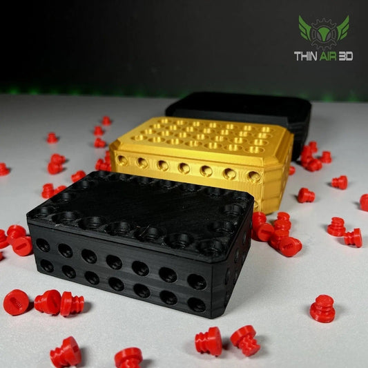 The Really Annoying Card Holder Gift Box featuring three colorful boxes in black, gold, and red, surrounded by red screws, ideal for adding a fun twist to gifts.
